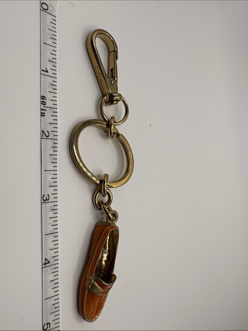 Cole Haan Gold Keychain with Orange Shoe Charm. NWOT
(# Cole Haan)